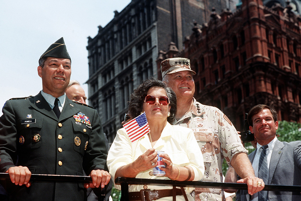 Army Gen. Colin Powell, chairman of the Joint Chiefs of Staff, left, Army Gen. H. Norman Schwarzkopf, commander of U.S. Central Command, and his wife, Brenda, ride in the welcome home parade, June 10, 1991, to honor the men and women who served in Desert Storm