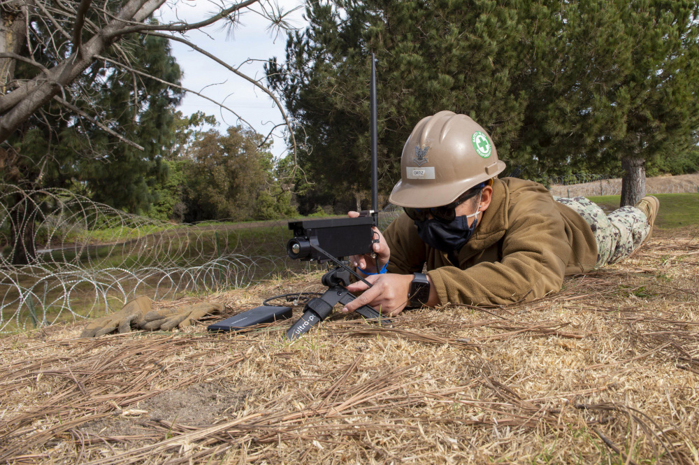 Petty Officer 2nd Class MaryJoy Ortiz, with Naval Mobile Construction Battalion 5, sets up surveillance cameras during the Naval Mobile Construction Battalion 5's second command post exercise onboard Naval Base Ventura County, Calif., Dec. 7, 2020.