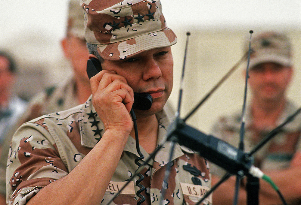 U.S. Army Gen. Colin Powell, chairman of the Joint Chiefs of Staff, speaks via satellite to the Pentagon while visiting troops during Operation Desert Shield