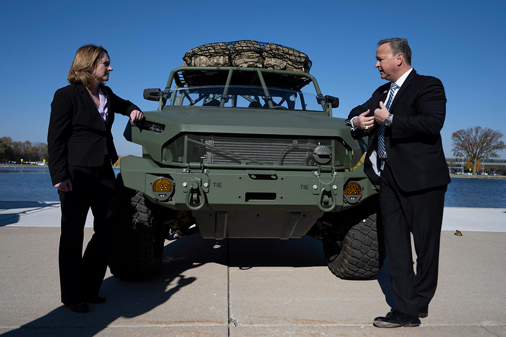 Deputy Defense Secretary Kathleen H. Hicks speaks with Stephen S. duMont, president of General Motors Defense, during a visit to GM and Wayne State University in Detroit, Nov. 8, 2021. Hicks traveled to Michigan to deepen relationships, discuss DOD priorities to address future warfighting needs, and reinforce the importance of manufacturing, renewable energy and green technology to U.S. national security.