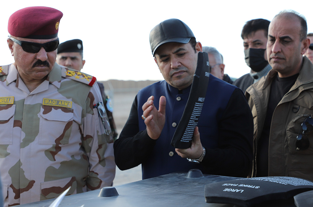 Qasim al-Araji, National Security Advisor of Iraq, and Iraqi Staff Lt. Gen. Abdul Amir al-Shammari, deputy commander, Joint Operations Command for Iraq, inspect body armor during a visit to Al-Asad Air Base last month. The Iraqi officials visited the base to get a firsthand look at how the new advise and assist relationship between U.S. and Iraqi forces is working.