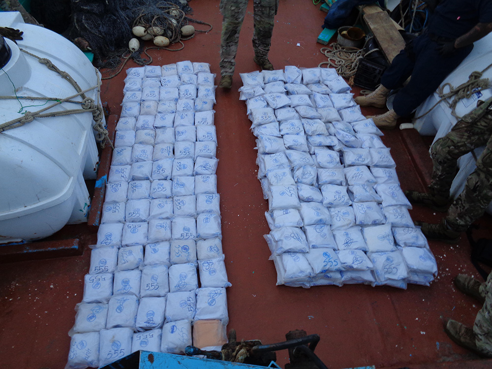 U.S. service members from coastal patrol ships USS Tempest (PC 2) and USS Typhoon (PC 5) inventory an illicit shipment of drugs while aboard a stateless dhow transiting international waters in the Arabian Sea. © U.S. Navy