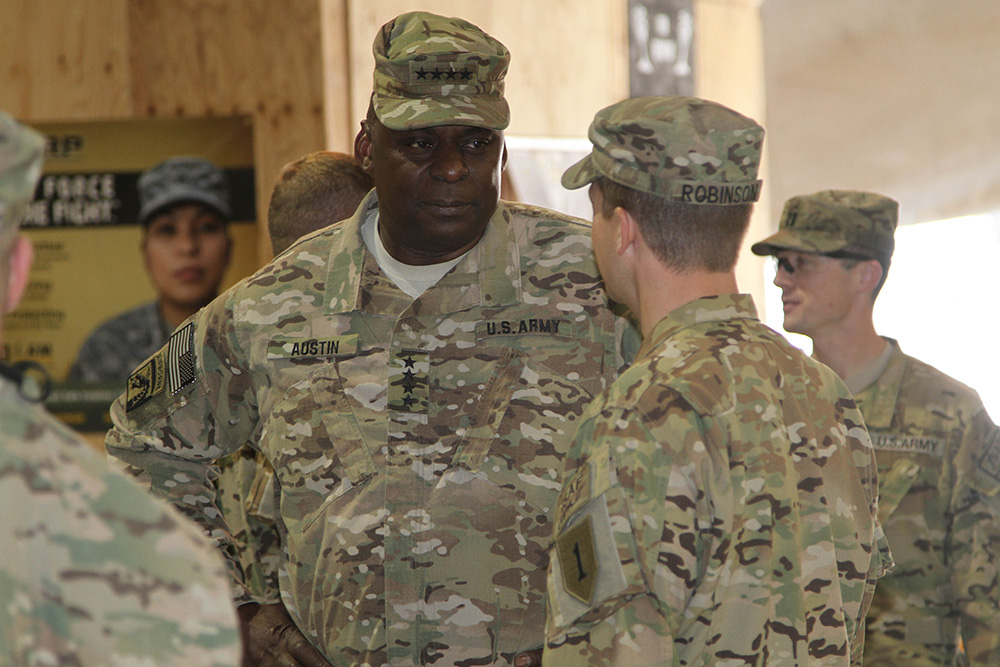 Then-Army Gen. Lloyd J. Austin III, commander of U.S. Central Command, speaks to a soldier with 1st Combat Aviation Brigade, 1st Infantry Division, after addressing troops Nov. 29, 2013, at Kandahar Airfield, Afghanistan. Austin visited Regional Command (South) on Nov. 28-29, 2013, to see service members and celebrate Thanksgiving with them. © Army Sgt. Antony S. L