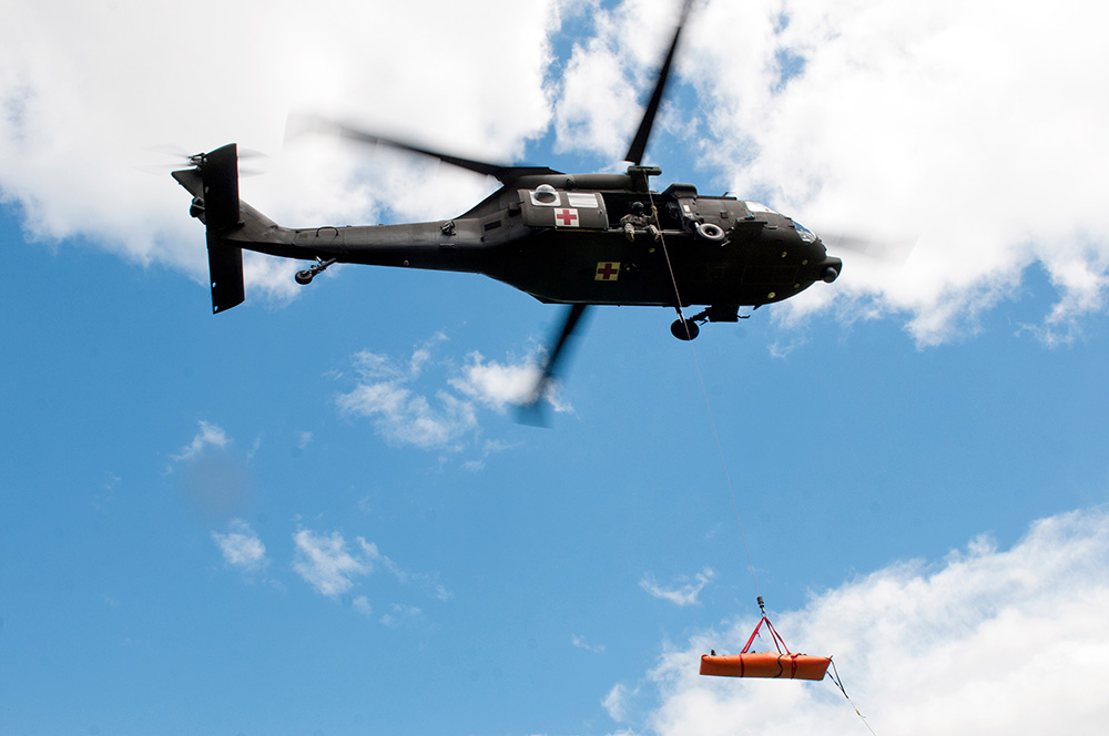An HH-60M Black Hawk helicopter hoists a simulated casualty during exercise Vigilant Guard 2016 at Camp Ethan Allen Training Site, Jericho, Vt., July 29, 2016. The exercise is a national emergency response exercise sponsored by the National Guard and U.S. Northern Command. © Army Spc. Avery Cunningham, National Guard