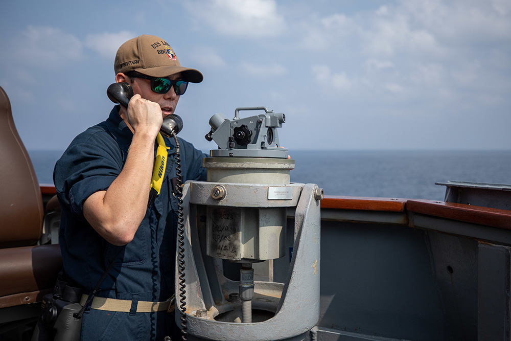 Navy Ensign Brendan Lee gives course changes while standing watch aboard the USS Laboon while the ship operates in support of Operation Prosperity Guardian in the Red Sea, Dec. 25, 2023. © Navy Petty Officer 2nd Class Elexia Morelos