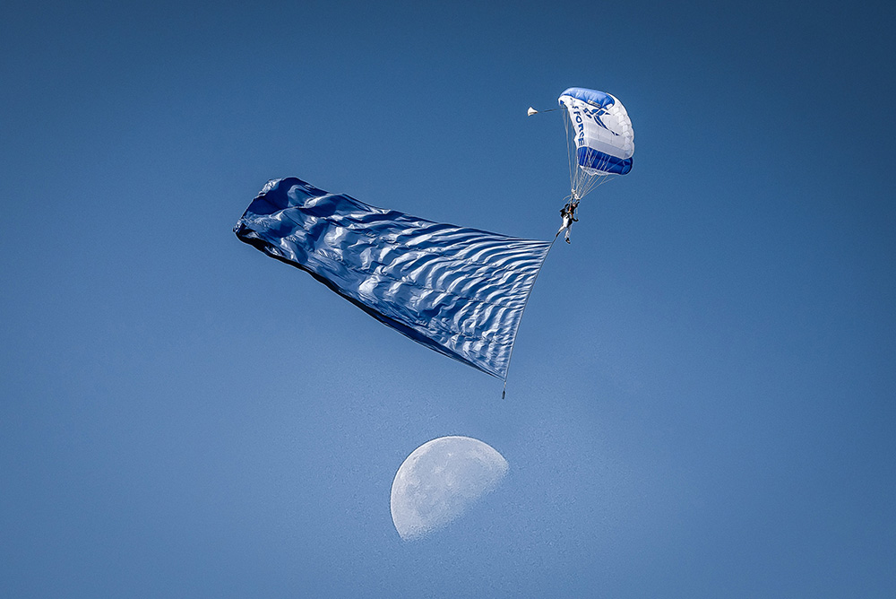 A member of the U.S. Air Force Academy’s cadet parachute team, lands on Steelman Field during a graduation parade in Colorado Springs, Colo., May 29, 2024. © Justin R. Pacheco, Air Force