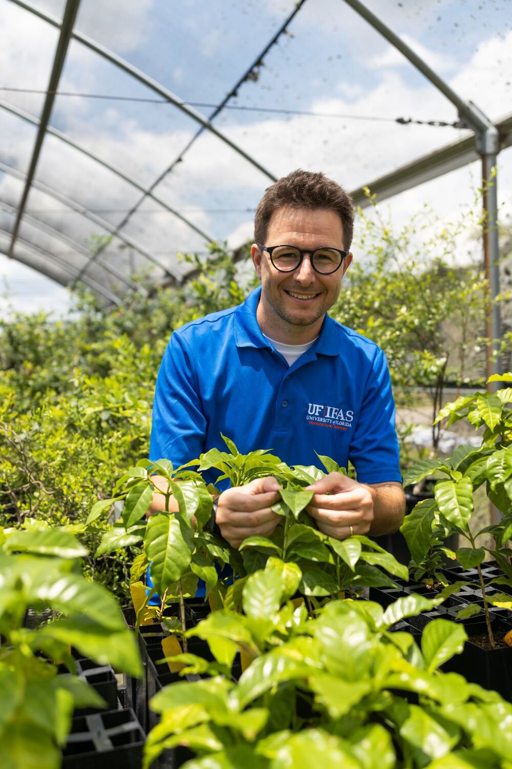 Felipe Ferrao with coffee plants. © Cat Wofford, UF/IFAS photography