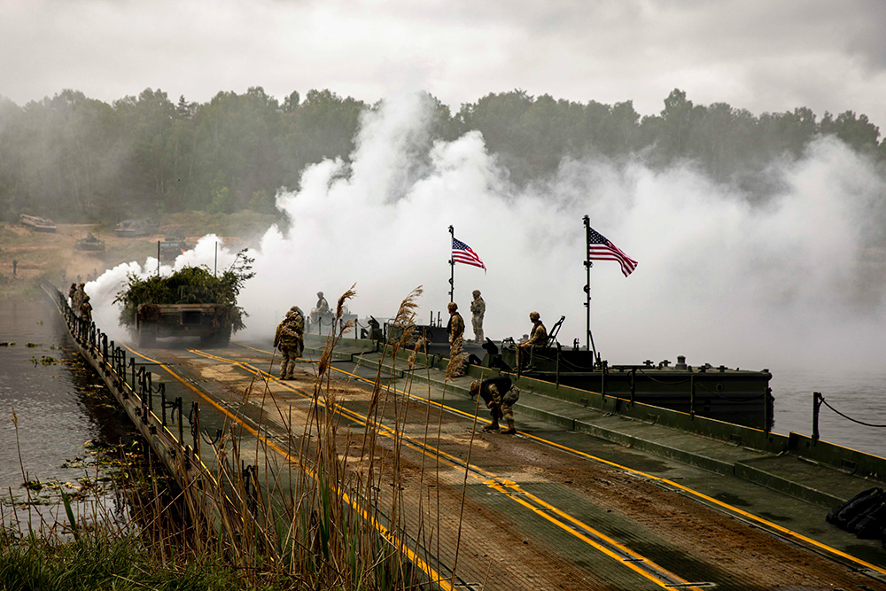 Soldiers conduct a wet gap crossing exercise during Defender, which is the largest U.S. Army exercise in Europe and is part of NATO's Steadfast Defender 24 exercise, at Drawsko Combat Training Center, Poland, May 11, 2024. A wet gap crossing is a tactical operation allows the transport of equipment and troops over a variety of wet terrain environments, which can save crucial time in wartime scenarios. © Army Reserve Sgt. Tamie Norris