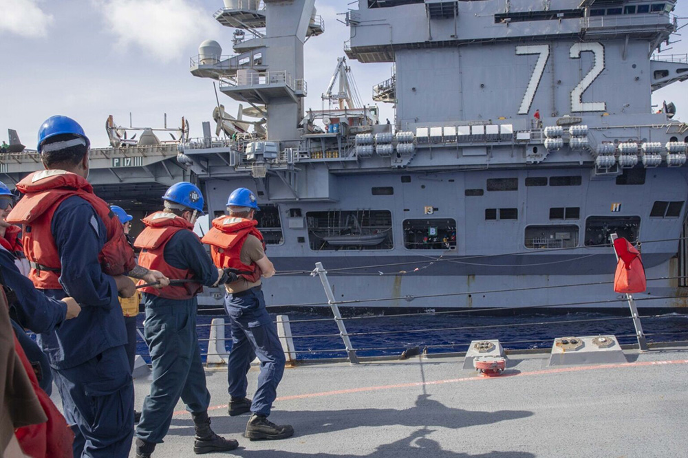 The destroyer USS Spruance sails alongside the aircraft carrier USS Abraham Lincoln during a replenishment-at-sea in the Pacific. The USS Abraham Lincoln Carrier Strike Group is underway to the U.S. Central Command’s area of operations. © Navy Seaman Joey Sitter