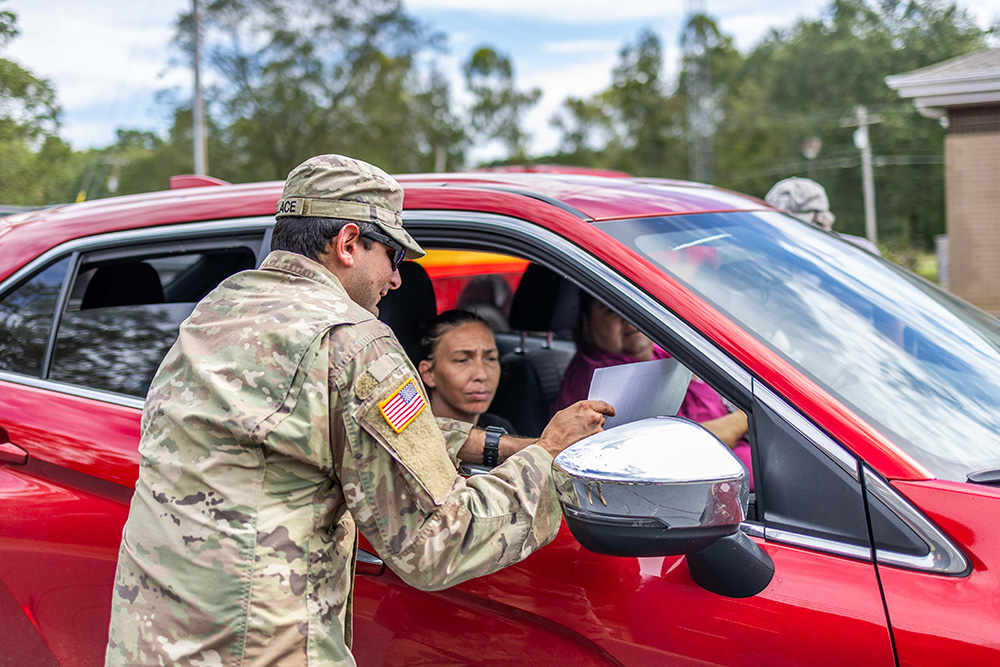 A South Carolina Army National Guardsman mans a distribution point for food, water and supplies for residents impacted by Hurricane Helene in Pickens, S.C., Oct. 1, 2024. © Army Spc. Turner Horton