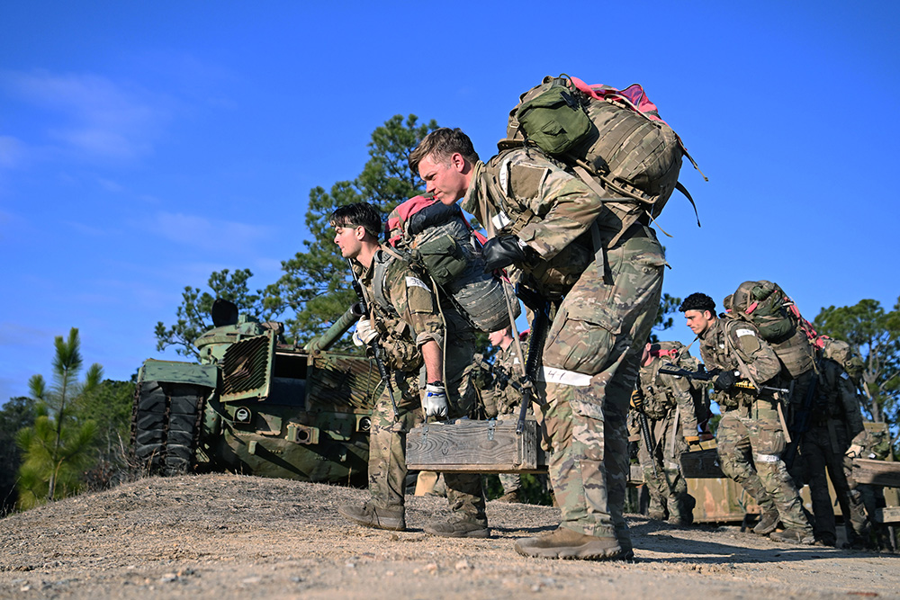 Candidates assigned to the U.S. Army John F. Kennedy Special Warfare Center and School carry weighted ammo crates as part of a long-distance movement during Special Forces Assessment and Selection at Camp Mackall, N.C. Jan. 19, 2024. Candidates who attended the three-week assessment and selection were evaluated on their ability to work individually and as a team. © K. Kassens, Army