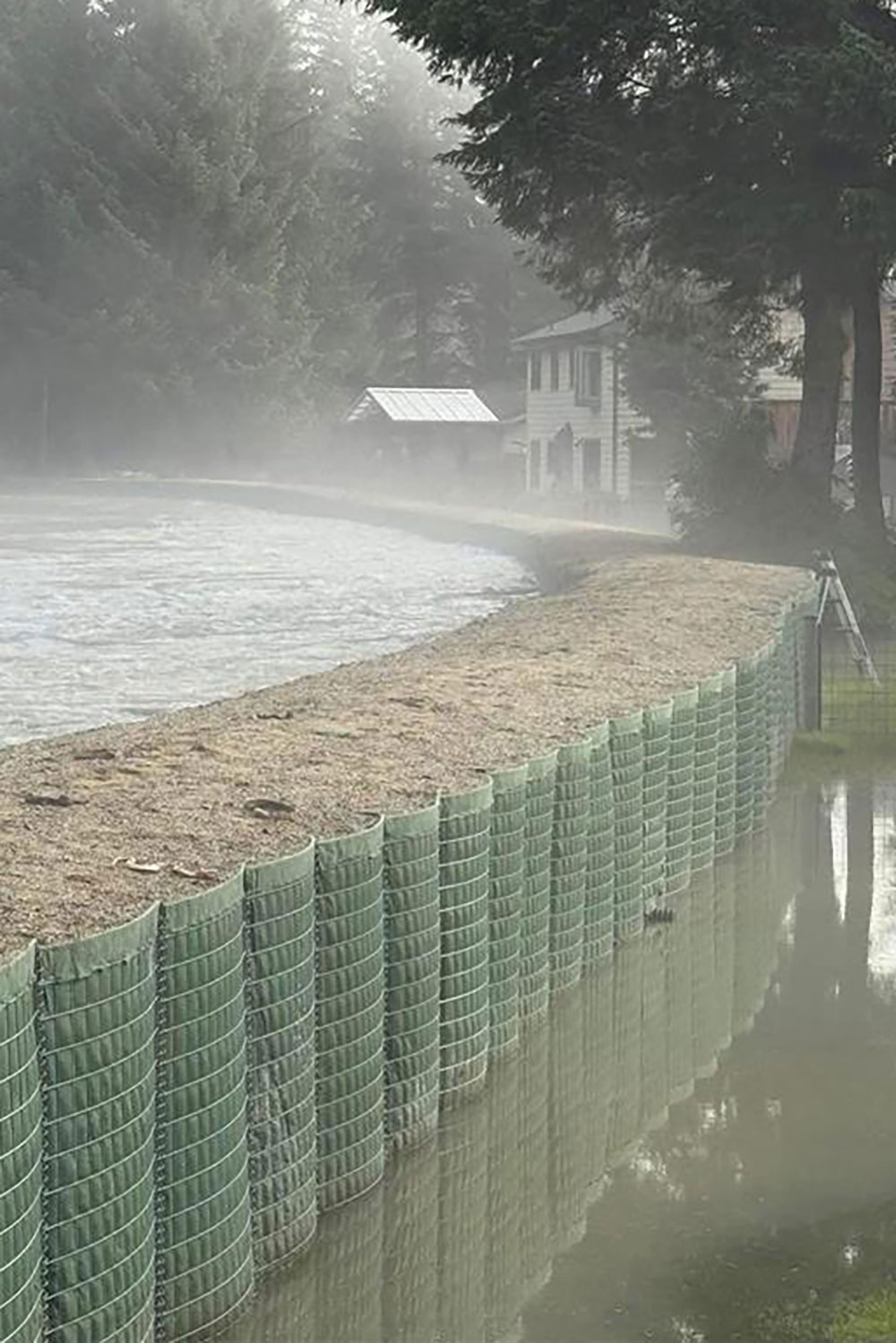 Originating from the U.S. Army Corps of Engineers National Flood Fight Materiel Center in Ill., about 37,800 linear feet of barrier wall, 400 supersacks, 112,000 sandbags and 25,000 linear feet of polyethylene sheeting were shipped to Juneau, Alaska, during the winter and spring of 2025 and strategically installed along the Mendenhall River by the city in two phases. As the lead federal agency for floods, the U.S. Army Corps of Engineers provided technical assistance and advisement to the community throughout the process. © U.S. Army Corps of Engineers National Flood Fight Materiel Center
